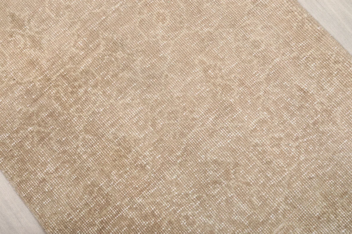 Close-up of the Faded Beige Geometric Anatolian Rug's surface, highlighting its vintage patina.