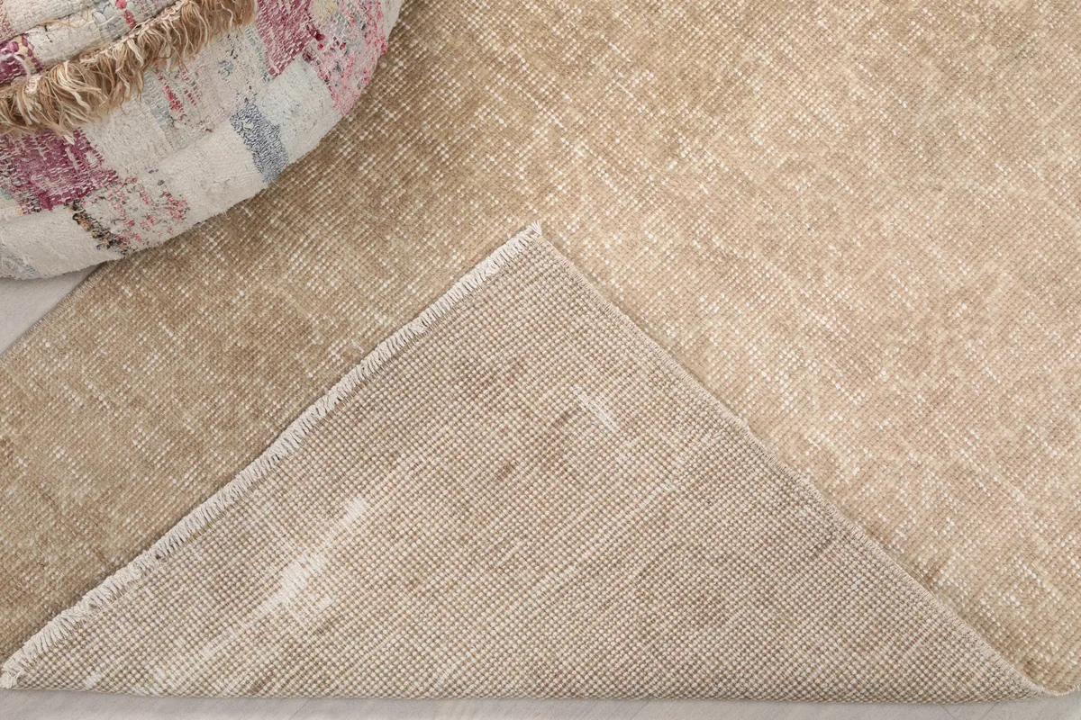 The back of the Faded Beige Geometric Anatolian Rug, revealing the hand-knotted cotton foundation.