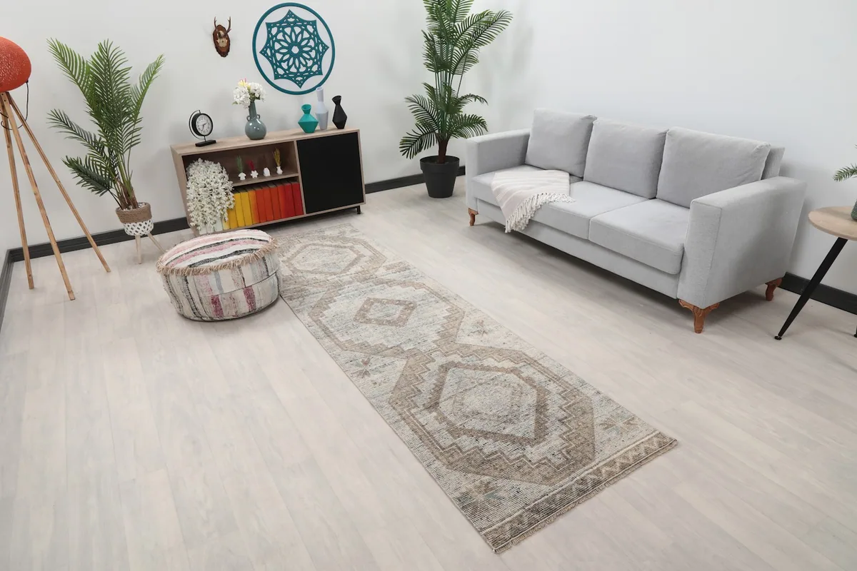 Angle view of the runner in a room setting, highlighting its muted beige and gray tones.