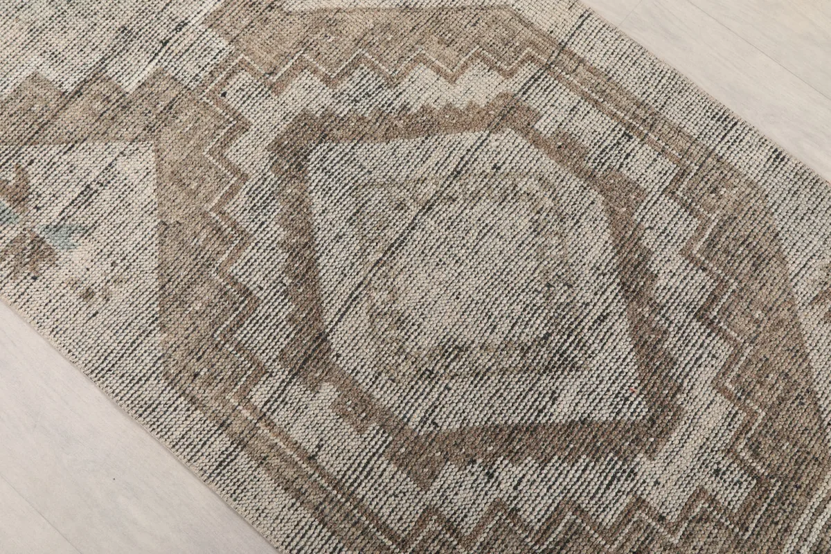 Close-up of a central geometric diamond motif, revealing subtle color variations and texture.
