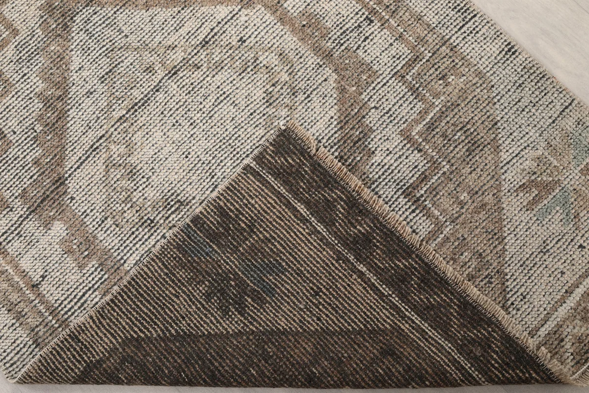 View of the reverse side of the runner, showing the cotton foundation and hand-knotted structure.