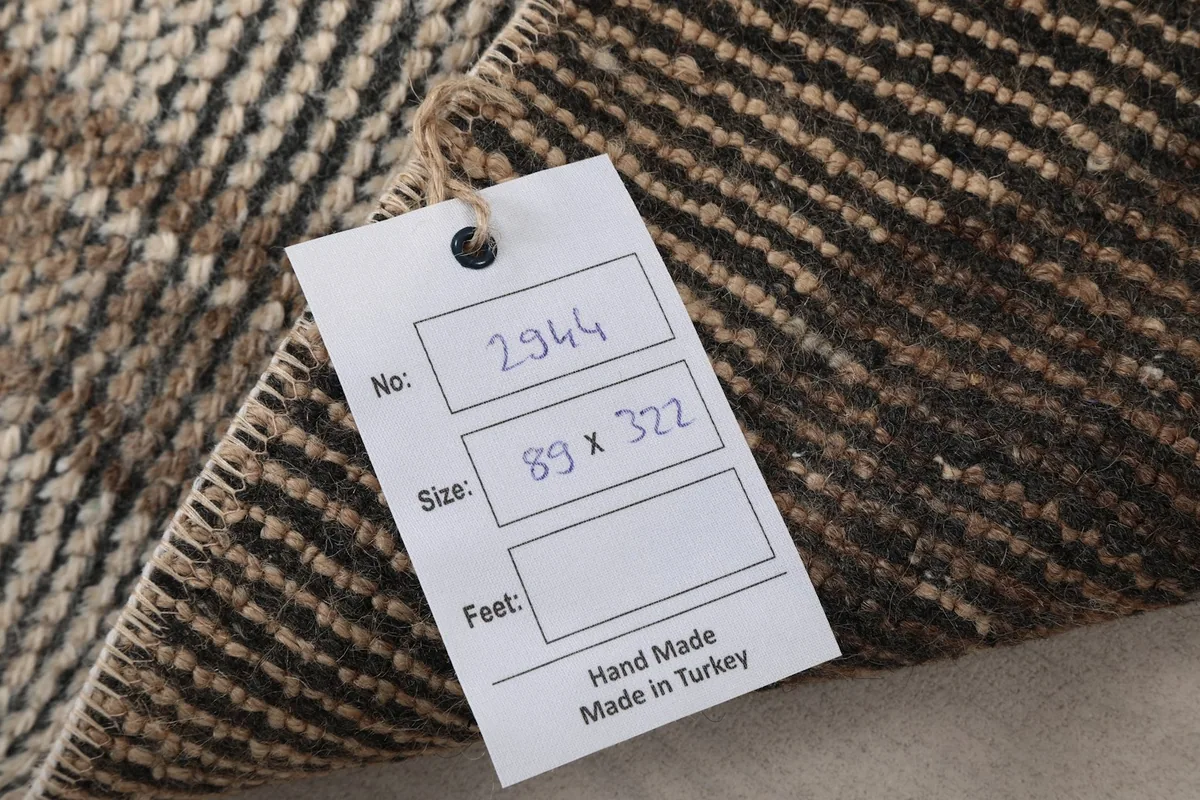 Tag showing the rug's product number and dimensions in centimeters, confirming it is handmade in Turkey.