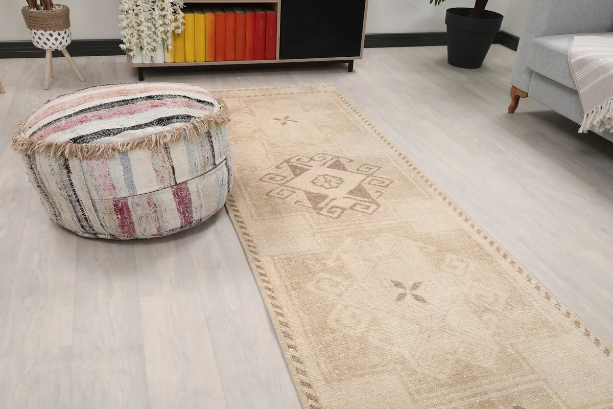 Close-up angle of the tan and brown runner rug's geometric pattern in a room setting