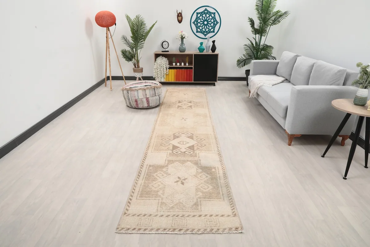 Vintage tan and brown geometric runner rug in a modern hallway setting