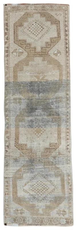 Full top view of the beige and gray geometric Anatolian runner on a white background