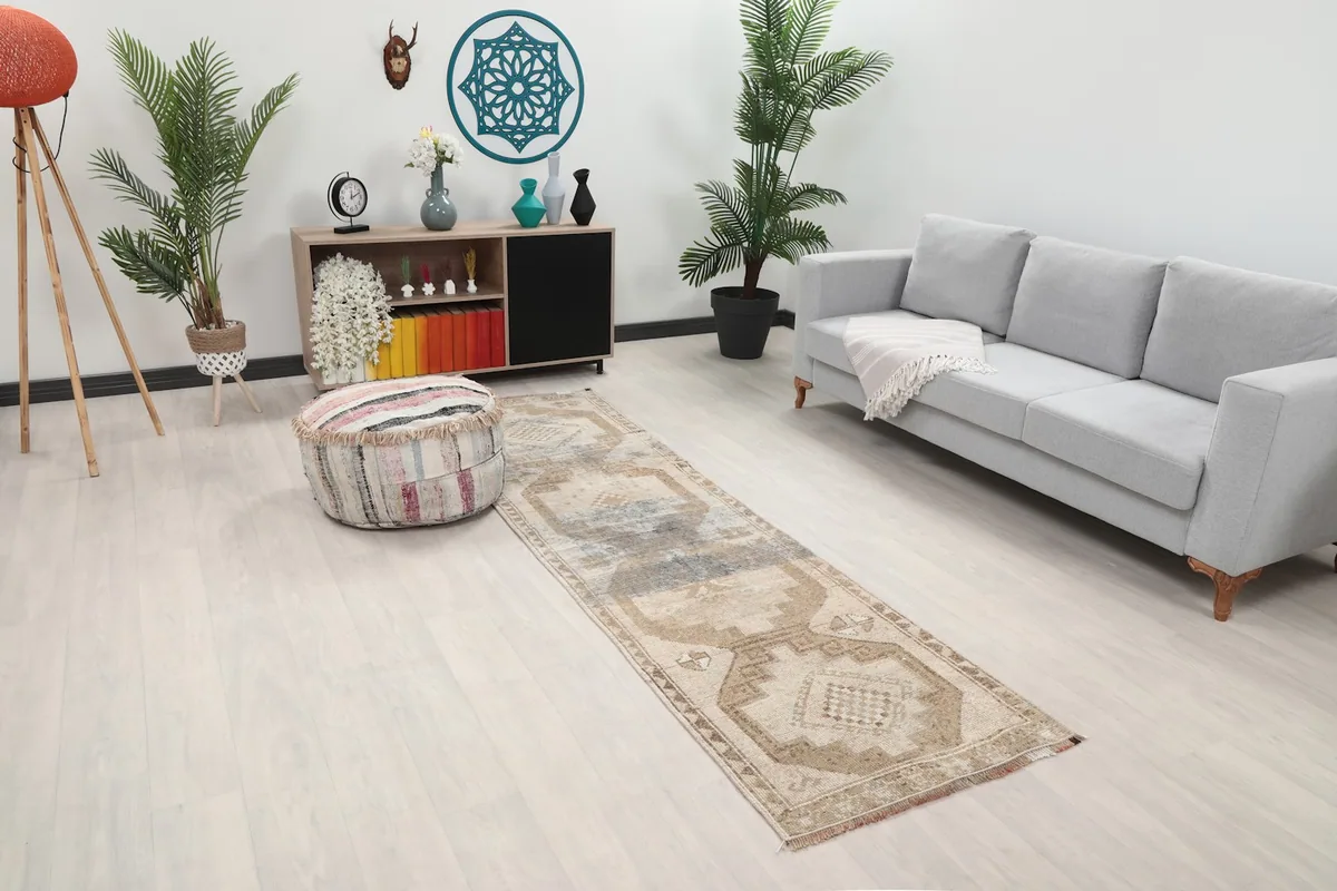 Angled view of the beige runner rug in a modern living space, showing its length