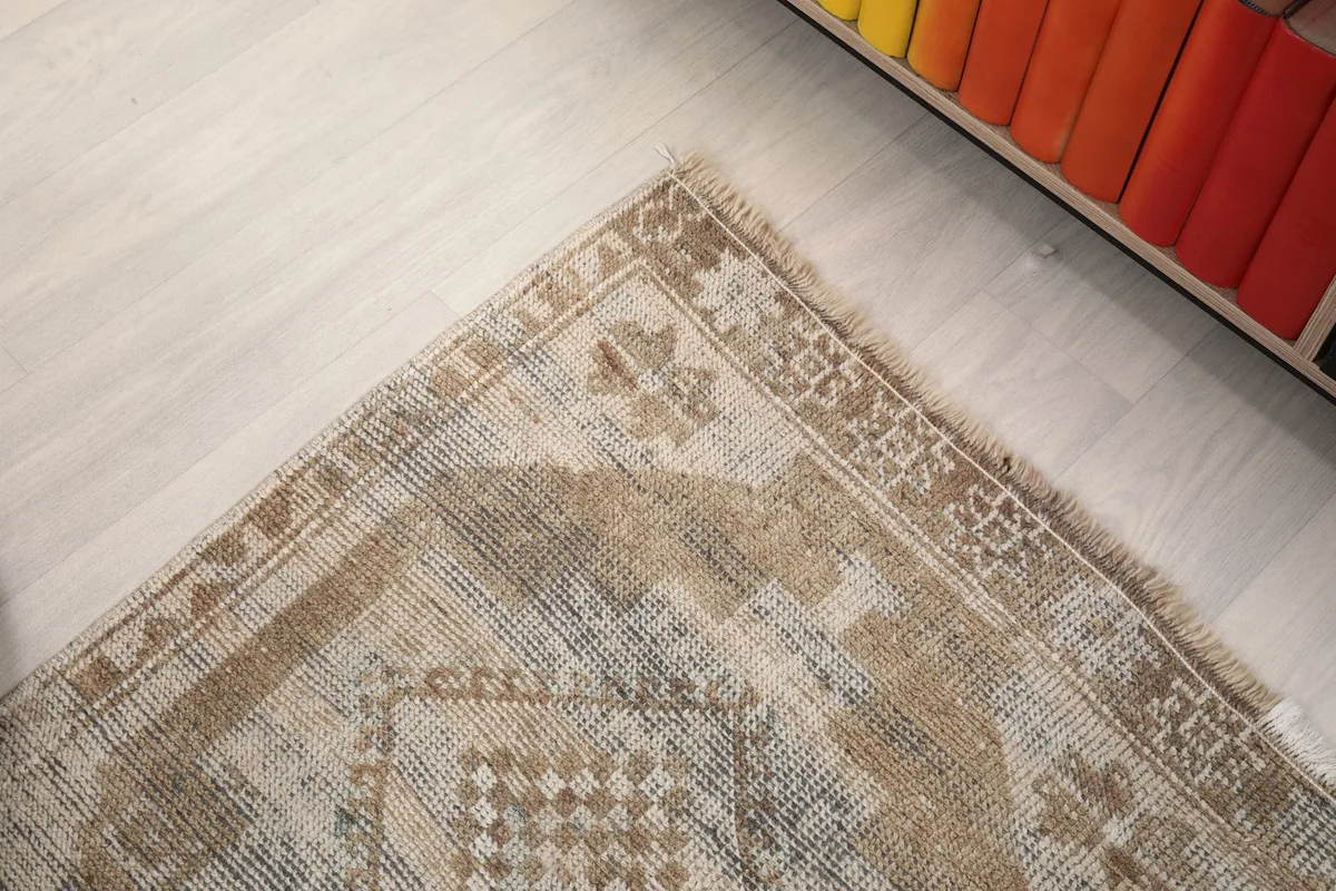 Close-up of a corner of the runner, revealing the intricate border design and slight wear