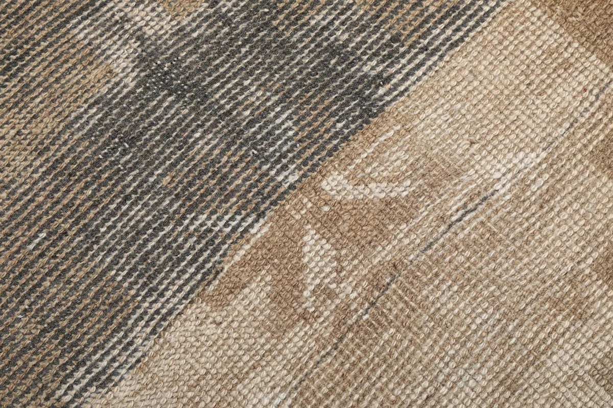 Extreme close-up of the low wool pile, showing the hand-knotted texture and color variations