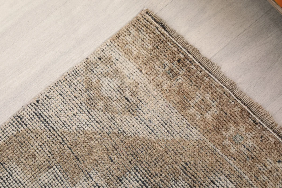 Corner detail of the runner, showing the low pile and vintage wear
