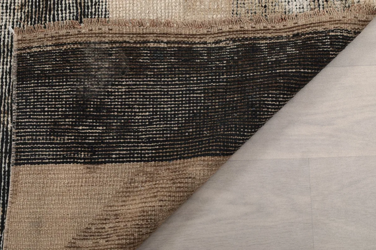Folded corner of the rug revealing the construction and thickness