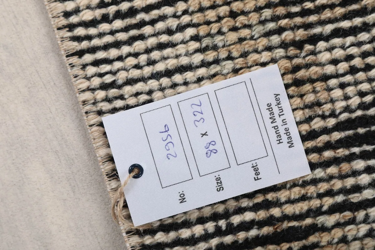 Product tag on the rug showing dimensions and origin details