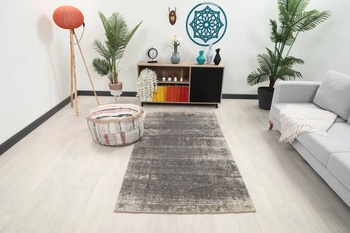 Vintage charcoal and gray rug in a modern living room setting with a light sofa
