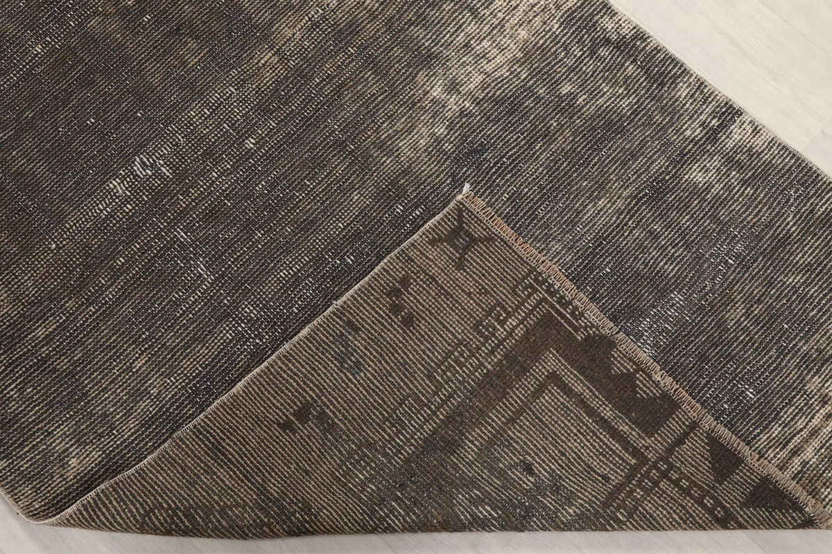 Underside of the rug, revealing the cotton foundation and hand-knotting structure