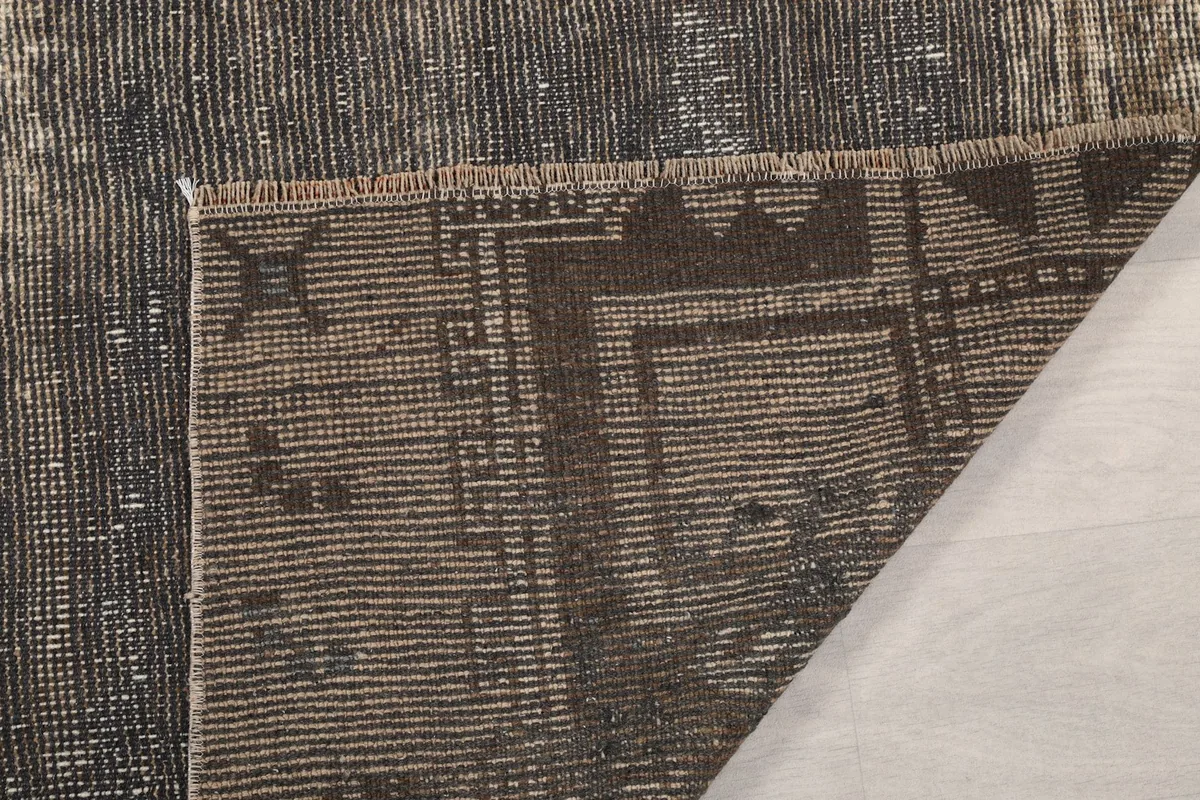 Close-up of the rug's reverse side, showing the intricate knotting and foundation