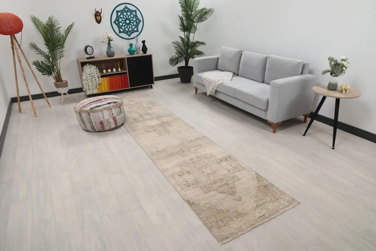 Angled view of the runner rug in a room, highlighting its neutral colors and design