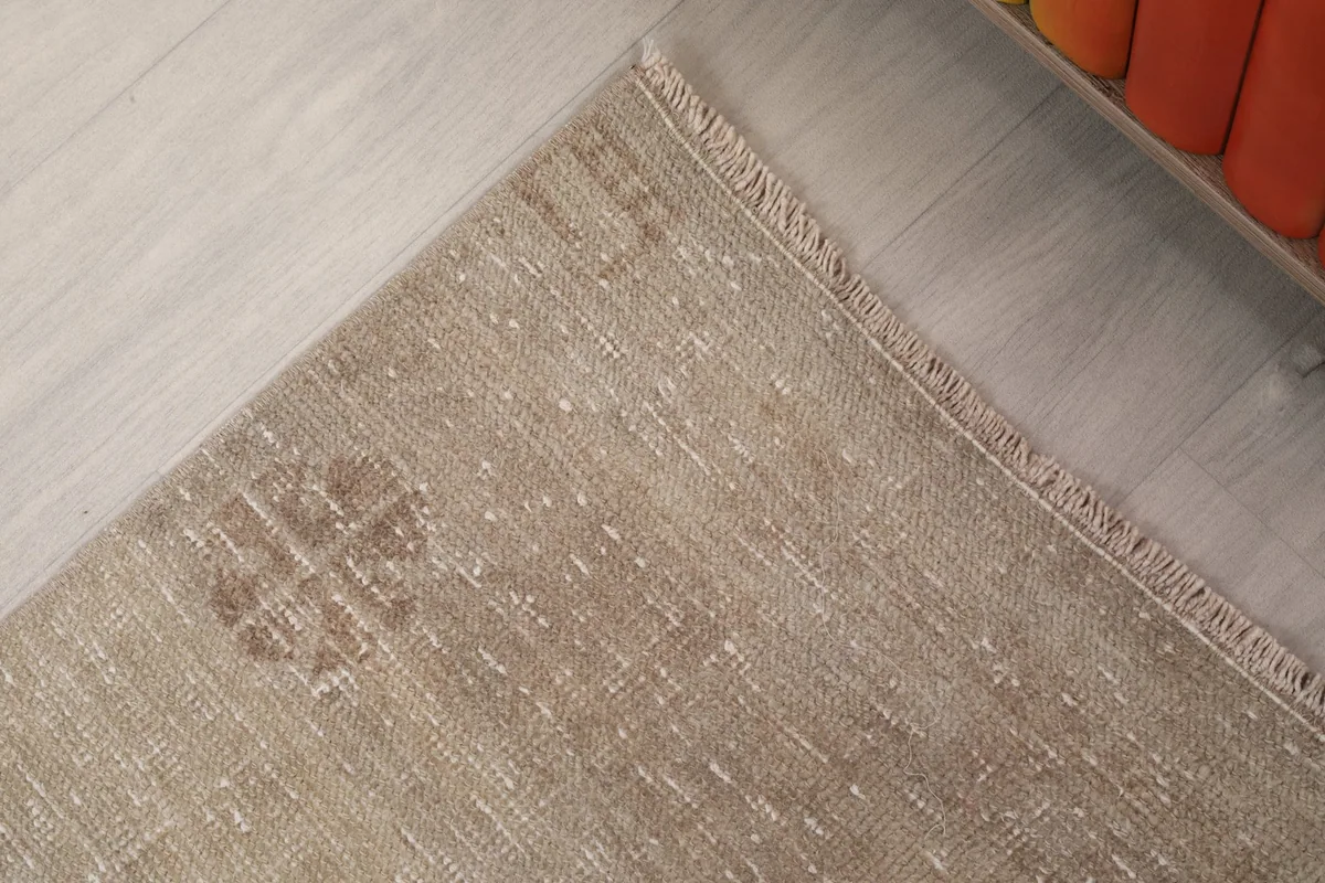Corner detail of the rug, showing the border design and fringe