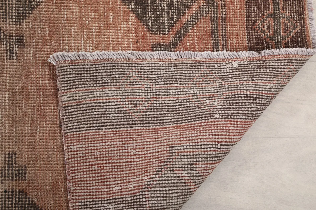 Close-up of the reverse side of the rug, showing the dense knotting and fringe