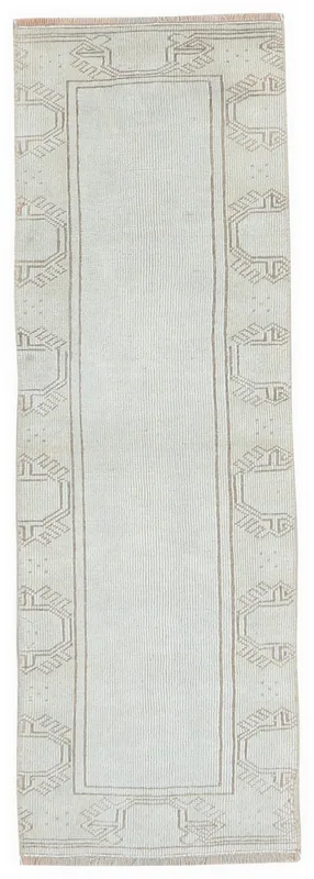 Full overhead view of the 1'8" x 5'5" vintage Anatolian runner rug with cream field and beige geometric border.