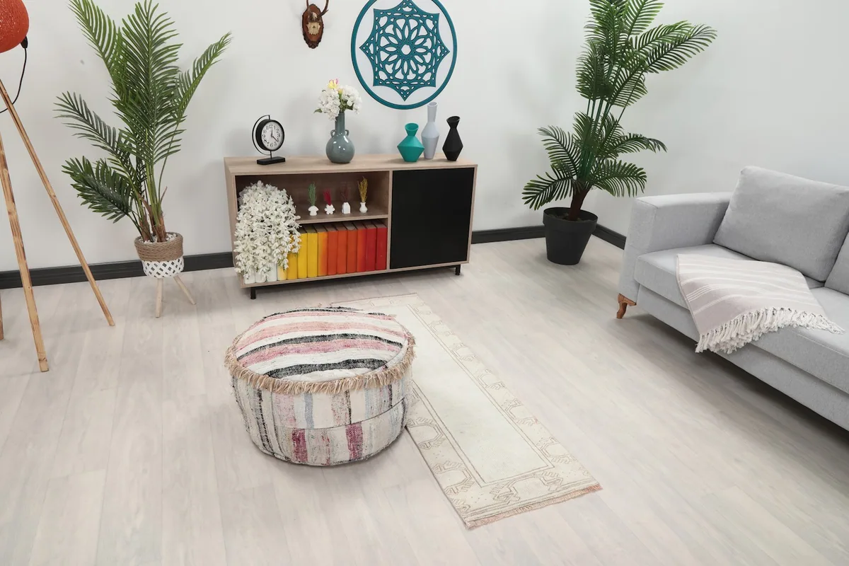 Overhead view of the cream runner rug in a room setting, highlighting its placement between furniture.
