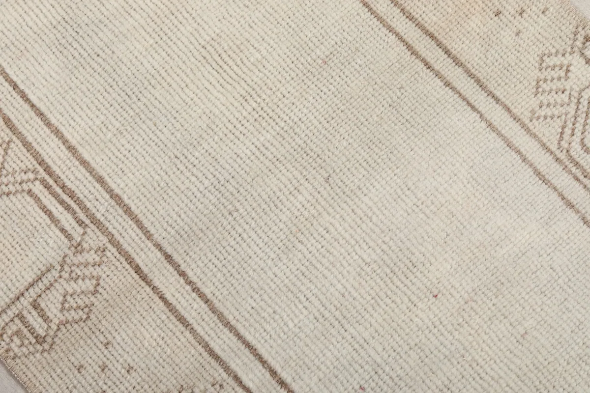 Close-up of the hand-knotted wool pile and cotton foundation, showing the texture and weave of the rug.