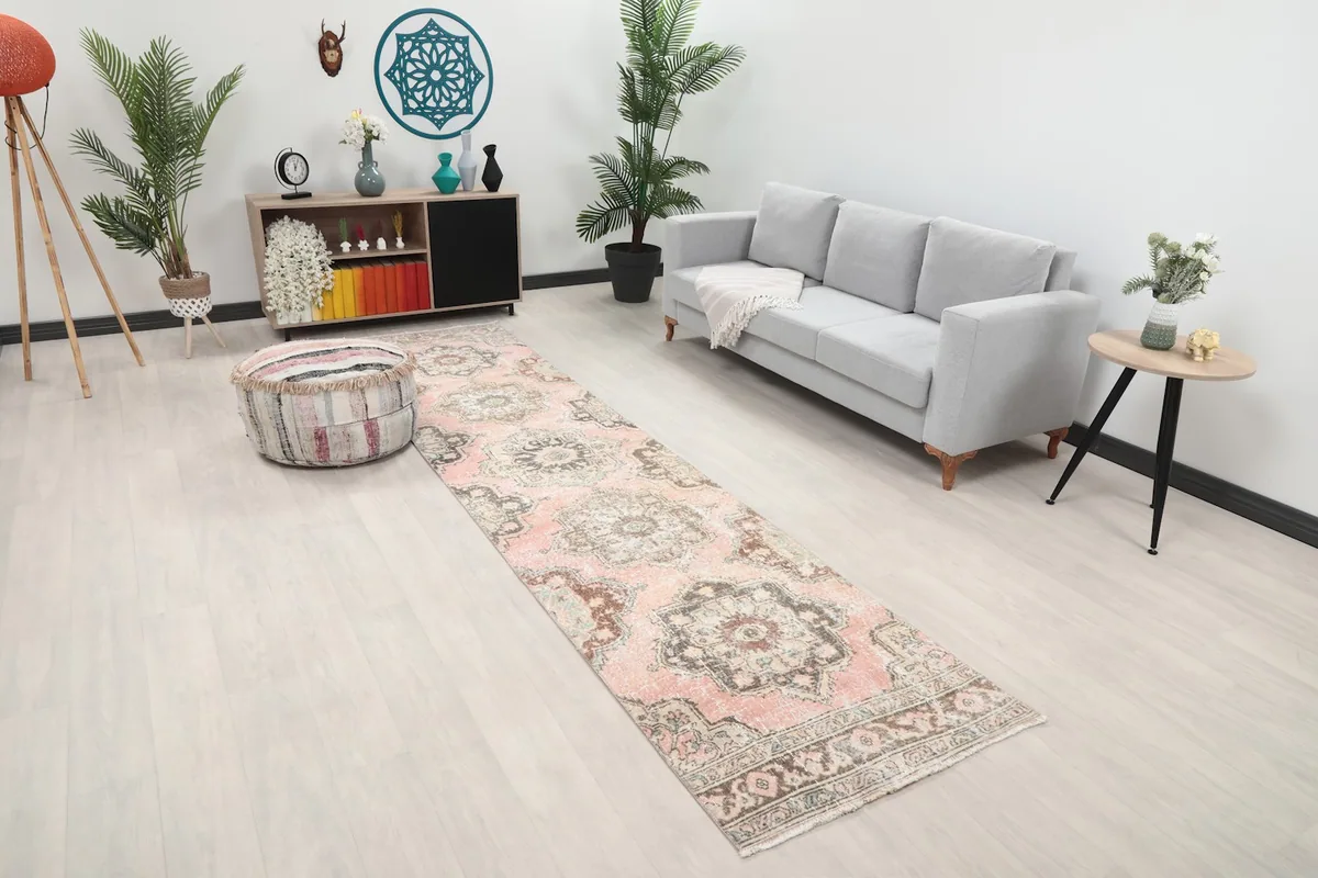 Angled view of the rose geometric runner rug in a room, showing its length and placement