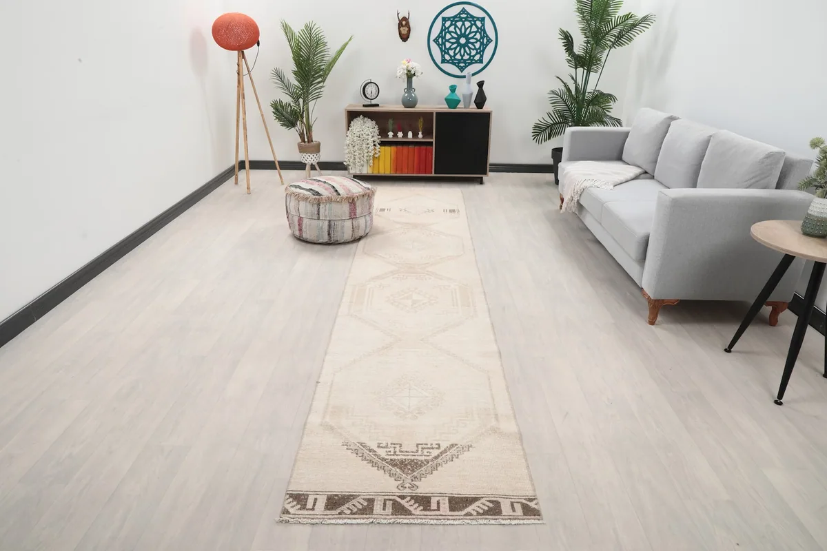 Beige geometric runner rug displayed in a modern living room setting with light flooring.