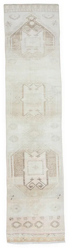 Full top view of the beige and brown Anatolian tribal runner on a white background
