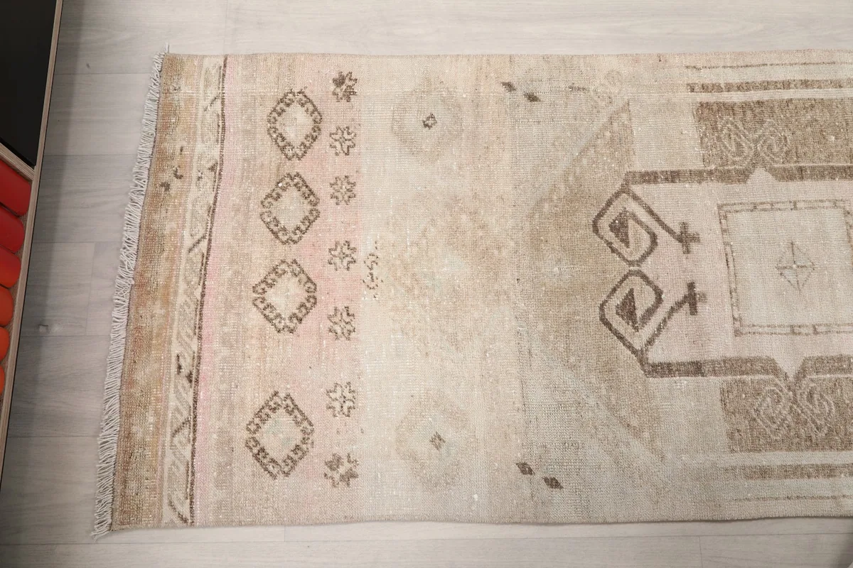 Close-up of another section of the runner, displaying various tribal symbols and color shifts