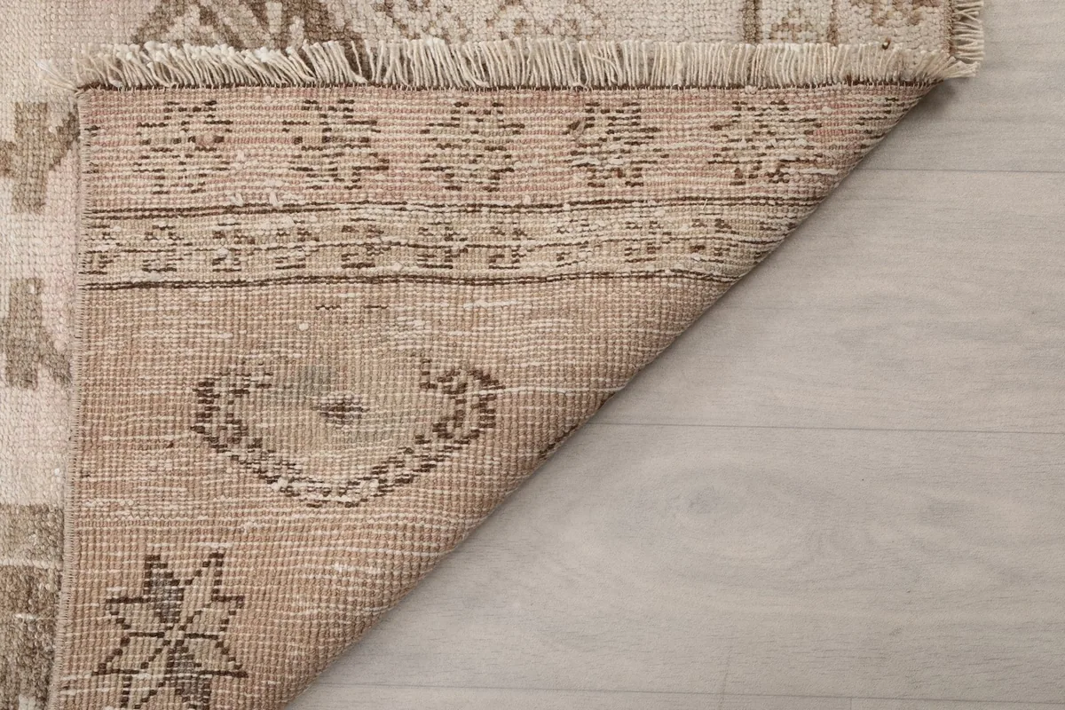 Another view of the rug's underside, showing the sturdy cotton foundation and knotting detail