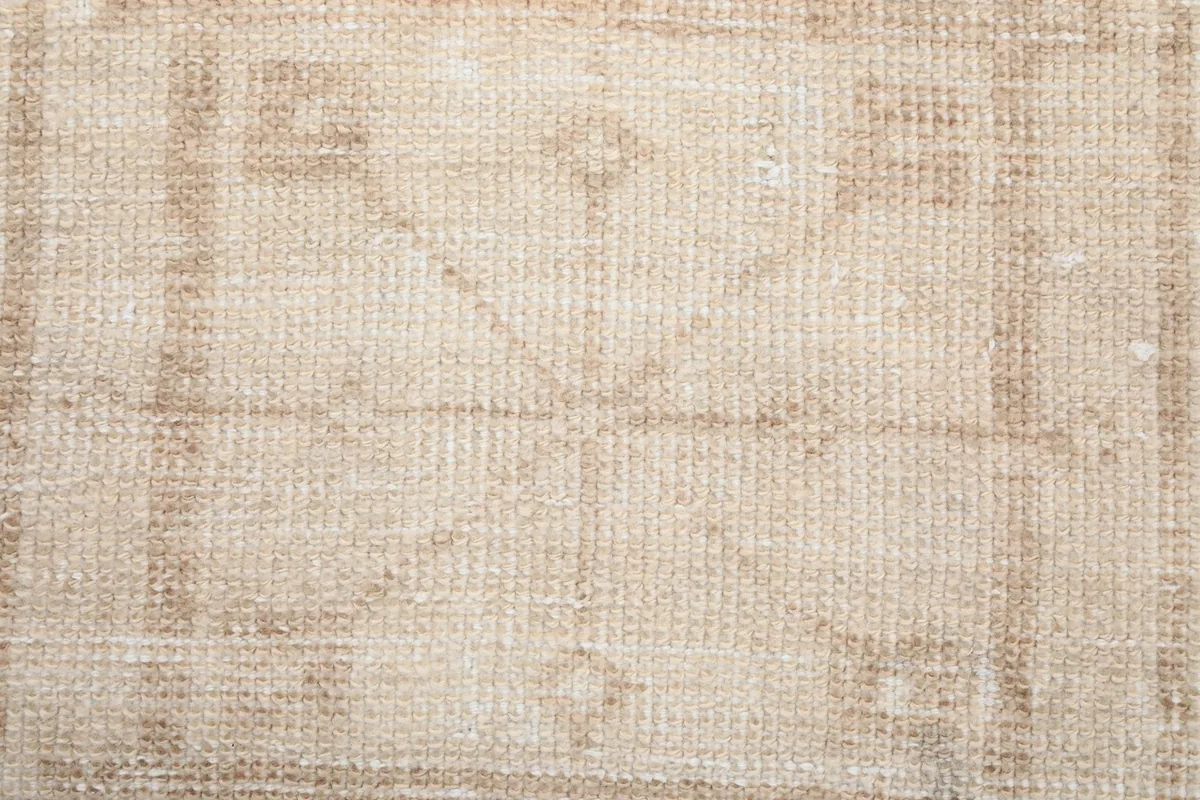 Detailed shot highlighting the low pile and intricate tribal-inspired patterns of the rug.
