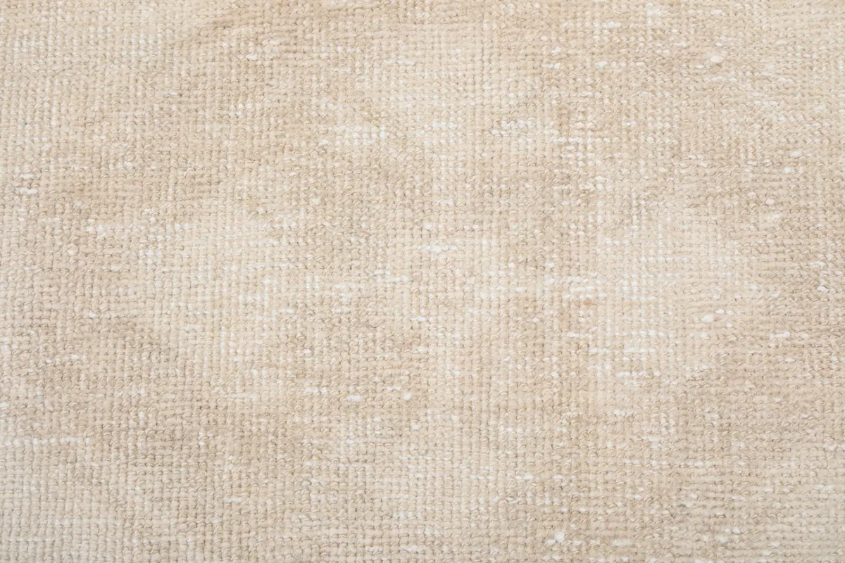 Extreme close-up of the hand-knotted wool pile, highlighting its soft texture and slight variations
