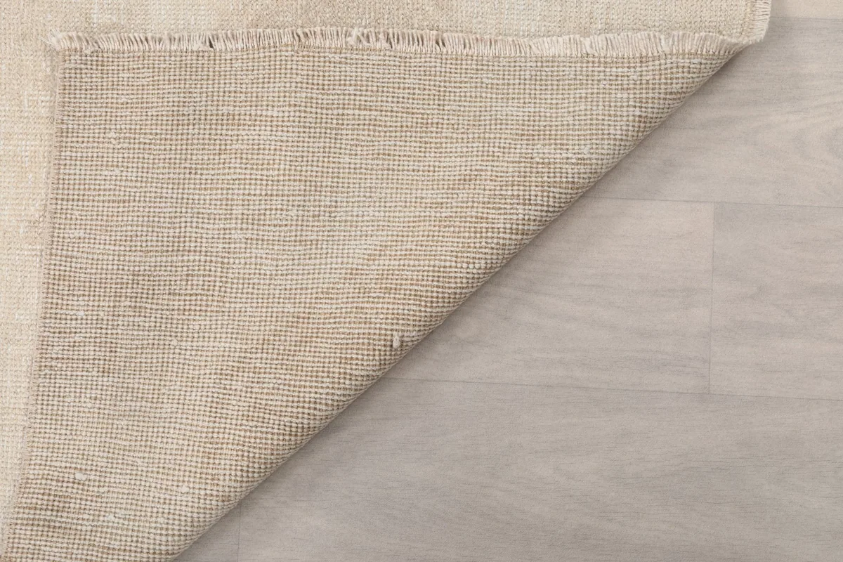 Close-up of the back of the rug, showing the tight knotting on the cotton foundation