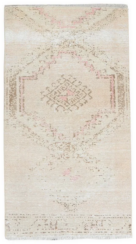 Full overhead view of the beige and pink tribal vintage rug