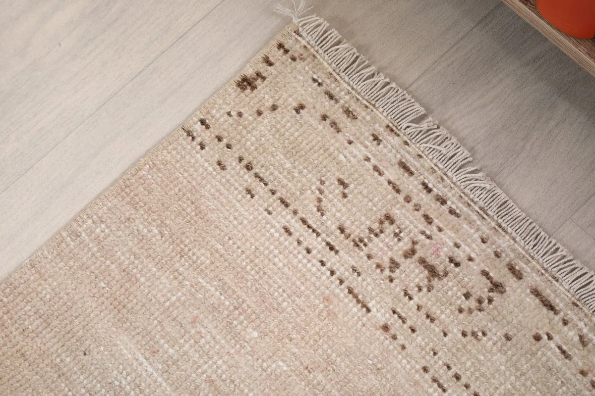 Close-up of the rug's edge and fringe showing the hand-knotted detail