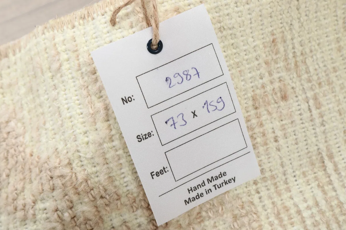 Product tag showing the rug's dimensions in cm and confirming it is hand made in Turkey