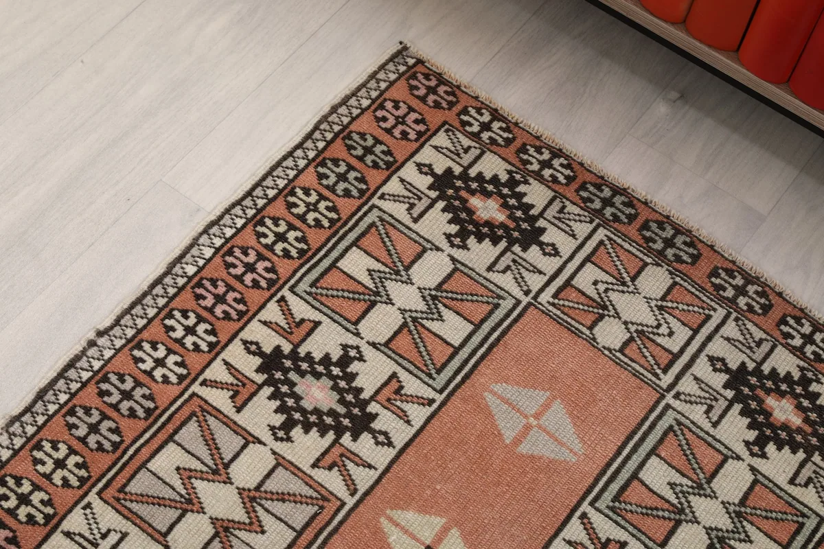 Detailed shot of the rug's border design and corner, showcasing the hand-knotted craftsmanship.