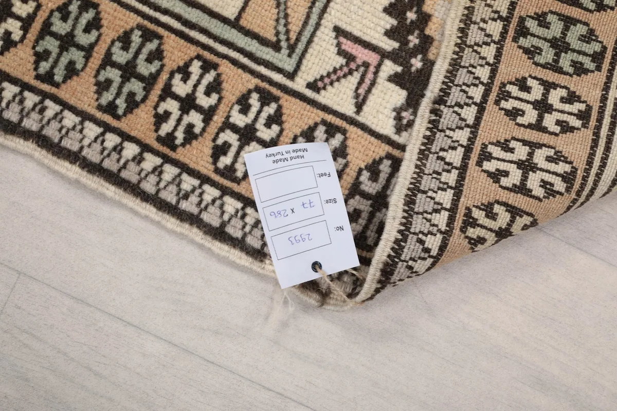 Corner of the rug with a product tag, showing the reverse side and the quality of the knots.