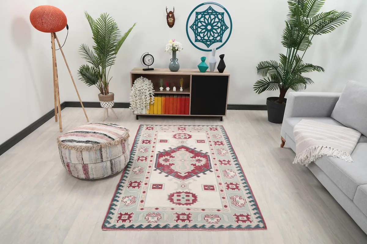 Vintage Anatolian rug in a living room setting with a light gray sofa and wooden cabinet