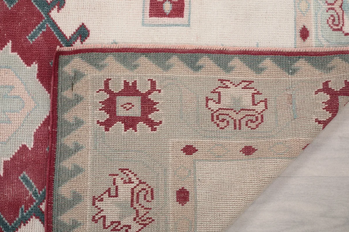 Close-up of the back of the rug, showing the intricate hand-knotted construction and foundation