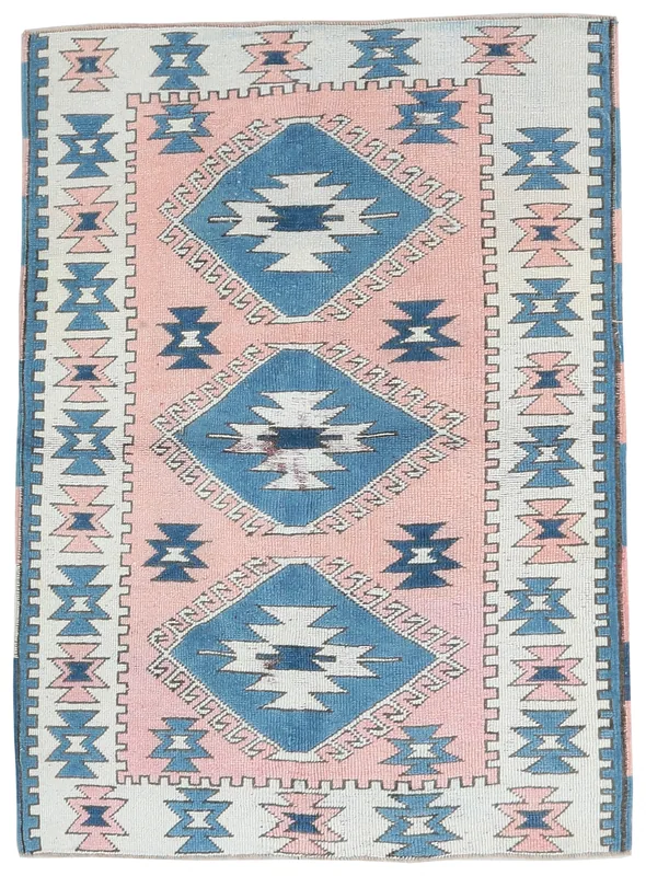 Full top view of the 3'7" x 5'0" pink and blue geometric vintage Anatolian rug on a white background.