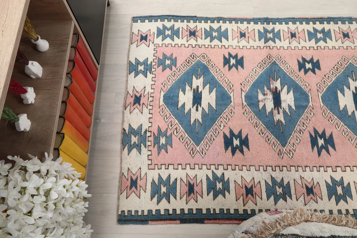 Overhead angle showcasing the rug's patterns and colors from one end in a room setting.