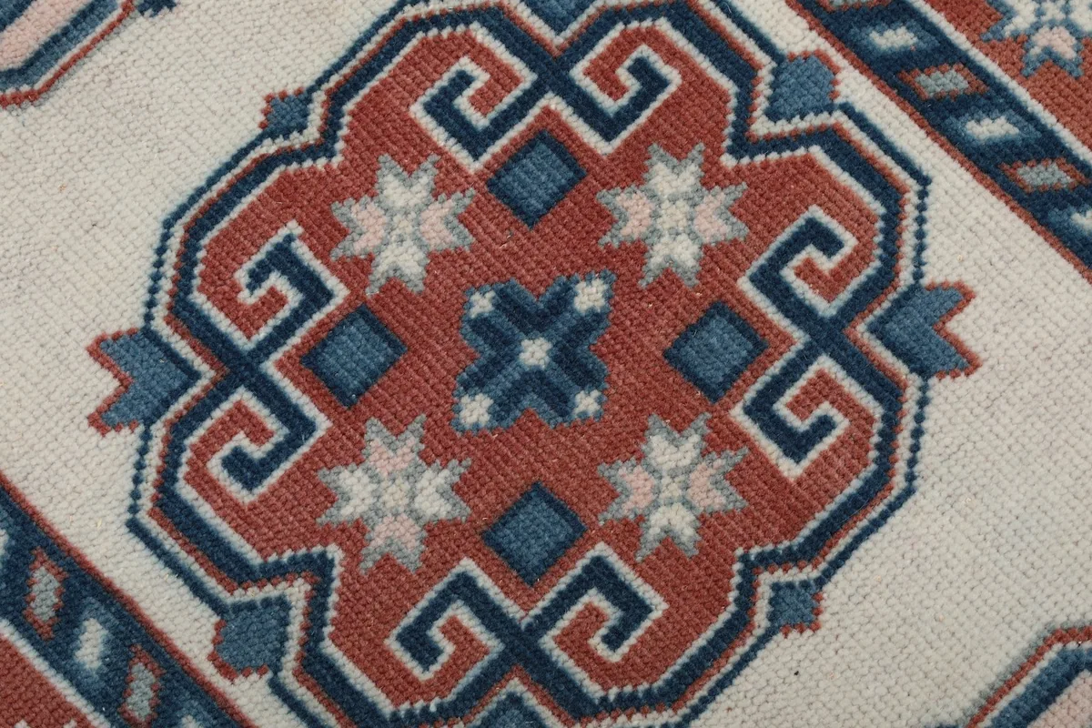 Macro detail of a rust and blue geometric medallion with star motifs