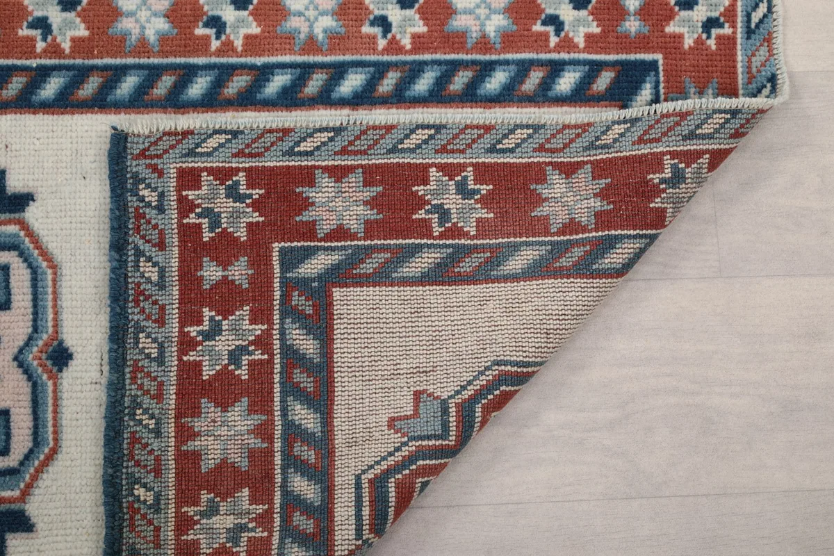 Underside view of the rug's corner, showing the hand-knotted construction and foundation