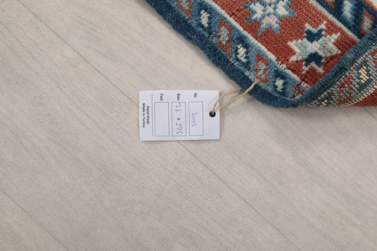 Close-up of the rug's tag, displaying measurements and origin information