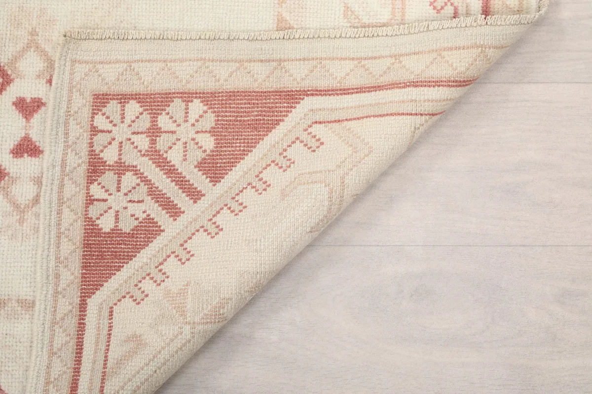 Underside of the rug, showing the cotton foundation and hand-knotted construction