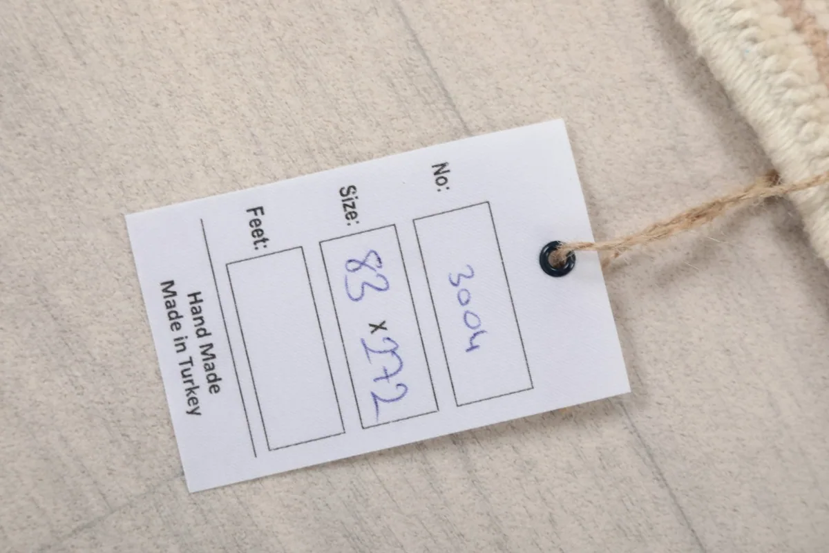 Product tag attached to the rug, displaying its size and origin