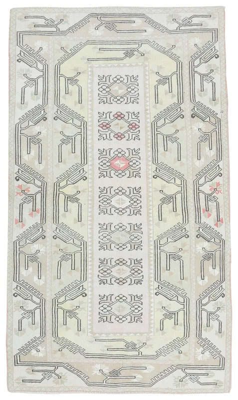 Full top view of the ivory and beige vintage Anatolian rug on a white background.