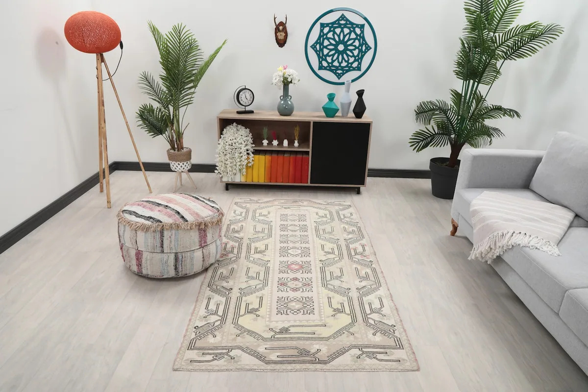 Vintage Anatolian rug in an inviting living space with light-colored furniture.