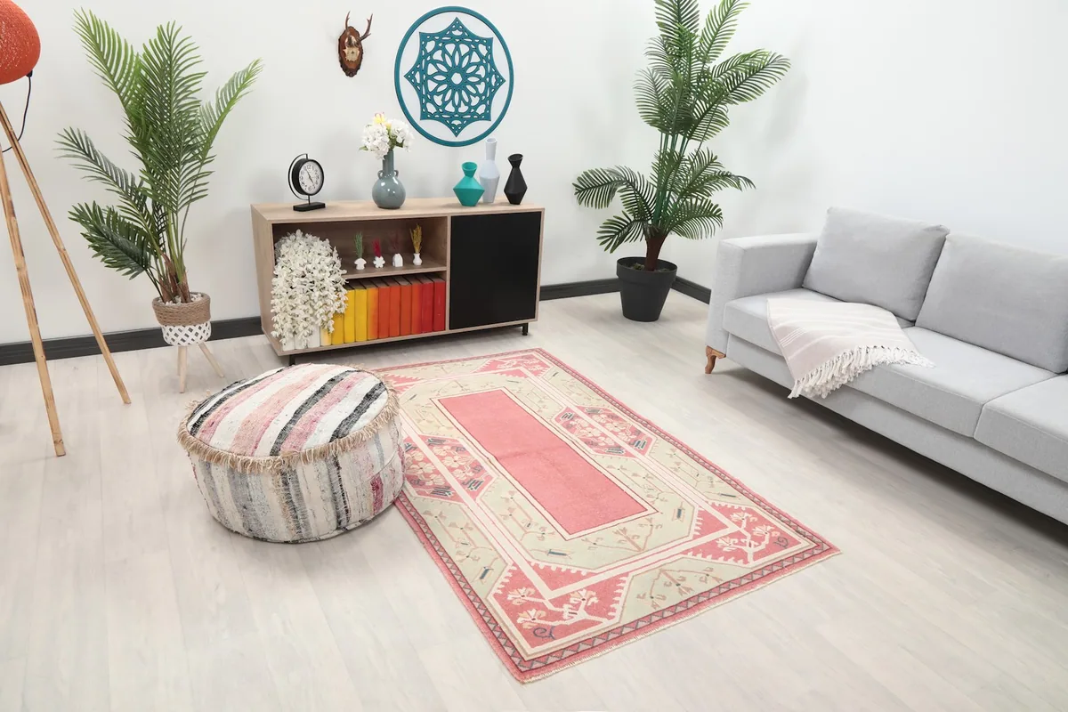 Angle view of the pink and green Anatolian rug showcasing its placement in a living area.
