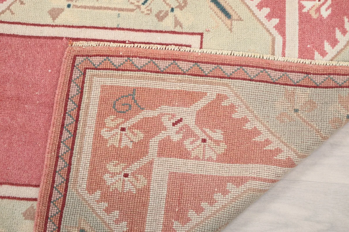 Close-up of a folded corner, showing the craftsmanship and the reverse side of the rug.
